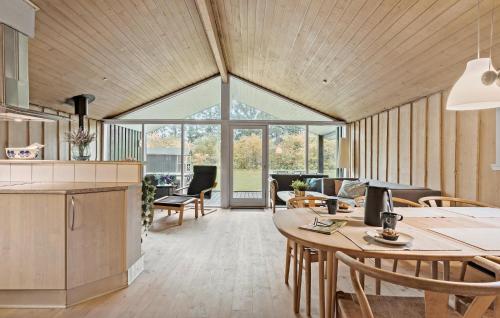 a kitchen and living room with a table and chairs at 4 Bedroom Pet Friendly Home In Bindslev in Bindslev
