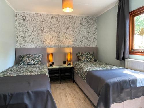 Ένα ή περισσότερα κρεβάτια σε δωμάτιο στο Ermerlodge
