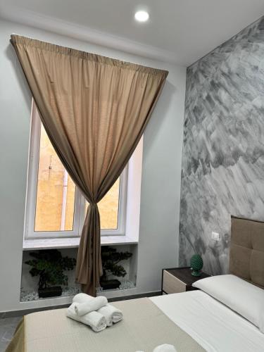 a bedroom with a bed and a window at Il Ritrovo Spa&Rooms in Naples