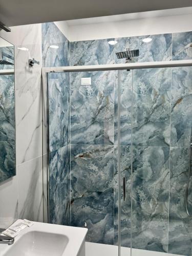 a bathroom with a shower and a sink at Il Ritrovo Spa&Rooms in Naples
