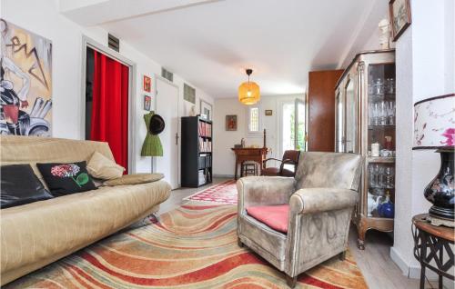 a living room with a couch and a chair at Awesome Apartment In Cagnes-Sur-Mer in Cagnes-sur-Mer