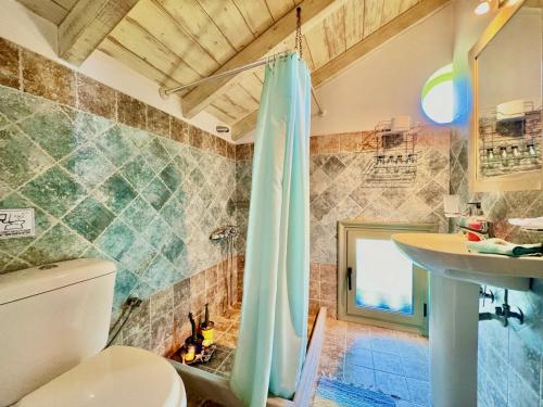 a bathroom with a shower and a toilet and a sink at Beach Villa Fotini with private pool by DadoVillas in Lefkada Town
