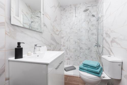 a bathroom with a sink and a toilet and a shower at Home2Book Cozy Beachfront Getaway in Tarajalejo in Tarajalejo