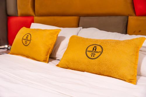 a bed with two yellow pillows on it at Montreal Magdalena Del Mar Hotel in Lima