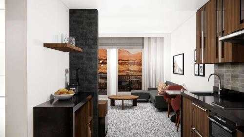 a kitchen and living room with a couch and a table at Black Desert Resort in Ivins