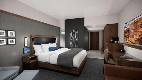a hotel room with a bed and a desk at Black Desert Resort in Ivins