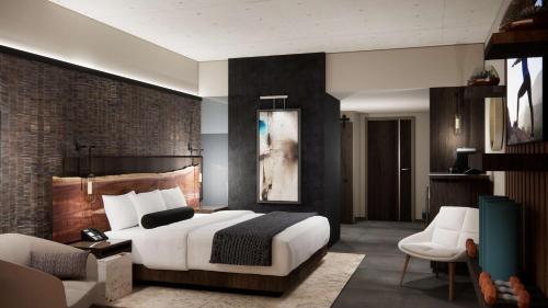 a bedroom with a bed and a couch and a chair at Black Desert Resort in Ivins