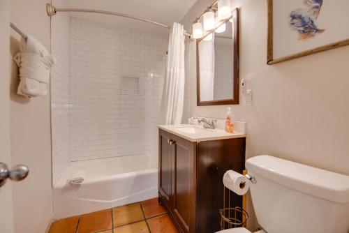 a bathroom with a toilet and a sink and a shower at Egret Suite - Southernmost Sanctuary in Key West