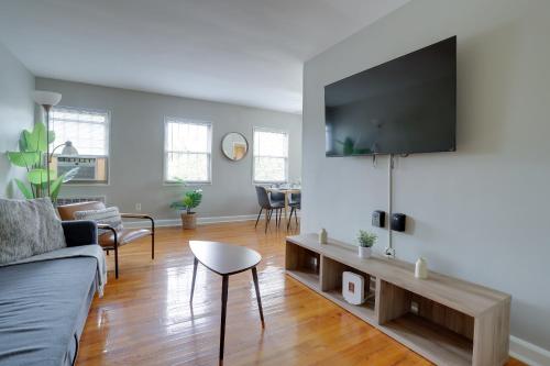 a living room with a couch and a flat screen tv at Prime Alexandria Location Corporate Apt in Alexandria