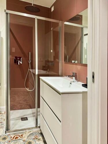 a bathroom with a sink and a shower at Appartamento Frida in Brescia