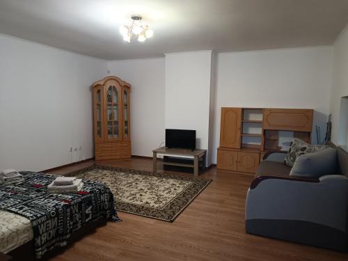 a living room with a bed and a couch at Apartments Domovik Beljaeva,5а in Mukacheve