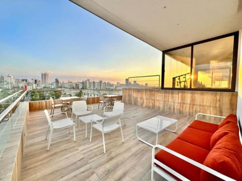 a living room with a couch and chairs on a balcony at Comfy 2BR City Center Condo in Los Prados
