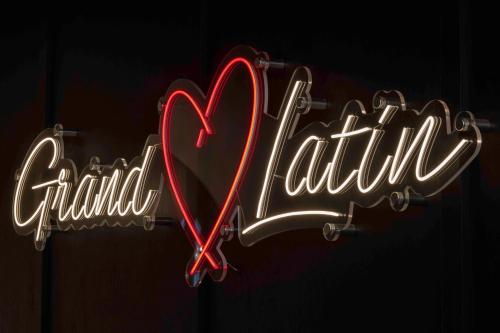 a neon sign that reads grandilitaire with a red heart at Hotel Grand Coeur Latin in Paris