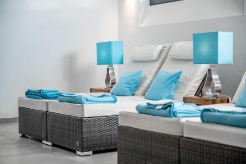 a room with a large bed with blue pillows at Ruhpoldinger Hof - Hotel & Wellness in Ruhpolding