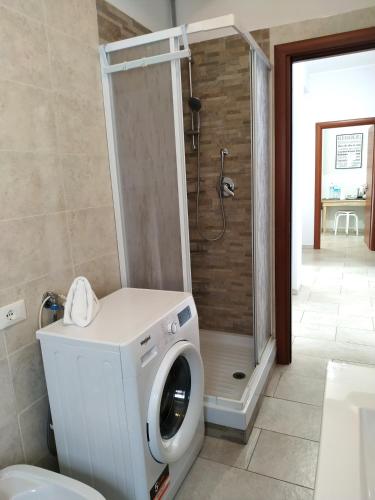 a washing machine in a bathroom with a shower at Aeroporto Ciampino - Casa Kennedy in Ciampino