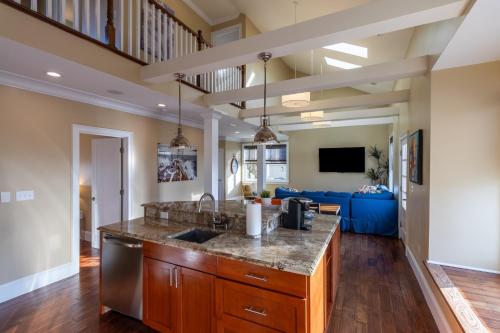 a kitchen with a counter top and a living room at The Newport Lofts - 546 Thames Street in Newport