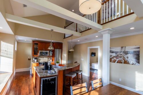 an open kitchen with a center island with bar stools at The Newport Lofts - 546 Thames Street in Newport
