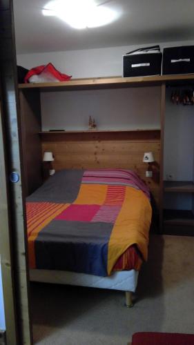 Dormitorio con litera y colcha colorida en RISOUL 1850, en Risoul