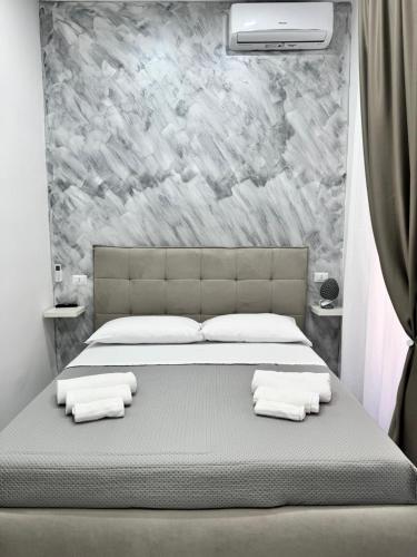 a bedroom with a bed with towels on it at Il Ritrovo Spa&Rooms in Naples