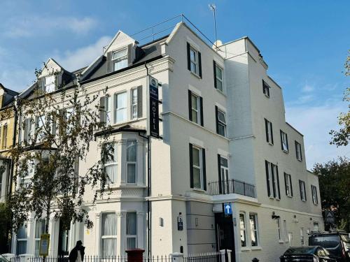 a large white building on a city street at Best Western Kensington Olympia Hotel in London