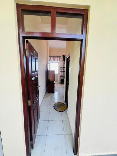 a hallway with a door and a tile floor at New Golden Bay Resort Weligama in Weligama