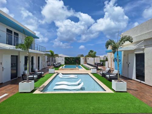 a swimming pool in the backyard of a house at Aruba Boutique & Art Hotel - Adults Only in Palm-Eagle Beach