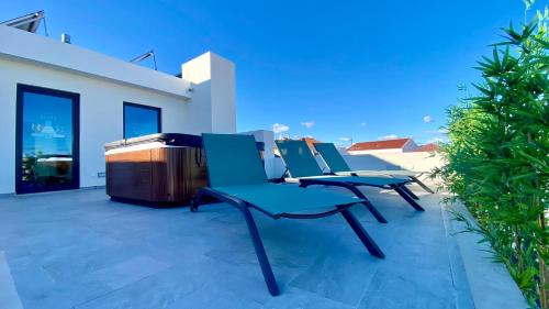 a group of chairs sitting on a patio at SIENNA Hotel in Rio Maior