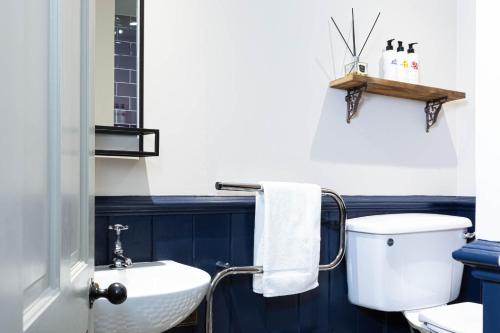 a bathroom with a white toilet and a sink at The Stag at Stow in Stow on the Wold