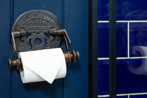 a roll of toilet paper hanging on a door at The Stag at Stow in Stow on the Wold