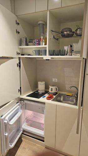 a small kitchen with white cabinets and a sink at Ponte della musica Teatro Olimpico in Rome