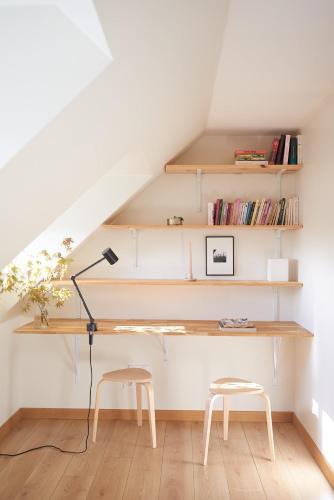 - un escalier avec un bureau et deux tabourets dans la chambre dans l'établissement bel appartement tout juste rénové, à Vierzon
