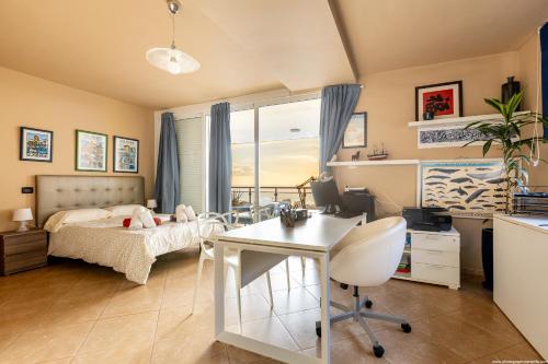 a bedroom with a bed and a desk and a table at Villa Amazing View Las Americas in Adeje