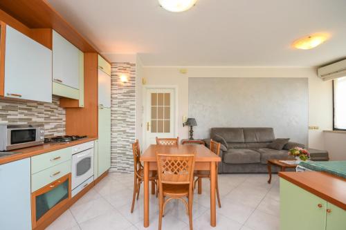 Una cocina y una sala de estar con una mesa y un sofá. en Appartamenti America, en Sirmione