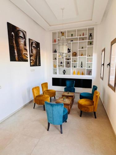 a living room with chairs and a table at Villa Palms de l'Atlas in Marrakech
