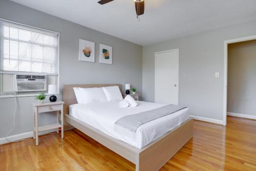 a white bedroom with a large bed and a window at Stylish Corporate Apartment in Alexandria in Alexandria