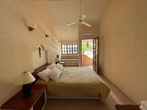 a bedroom with a large bed and a window at Casa Don Pedro in Apozol