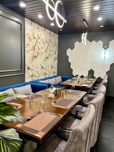 a dining room with long tables and chairs at The Olive Hotel Srinagar in Srinagar