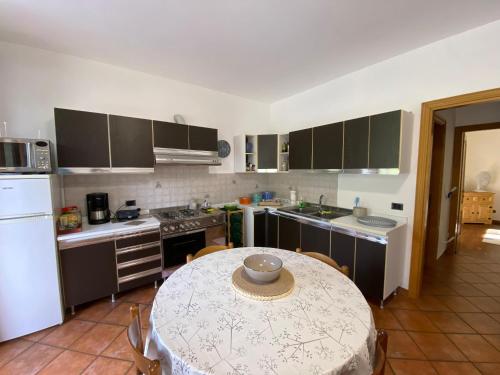 a kitchen with a table and a kitchen with a table and a tableablish at Casa Mailinne in Baveno