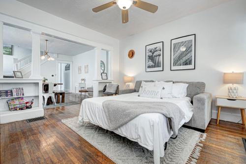 a white bedroom with a bed and a couch at 6 Bedroom Duplex Sleeps 14 Close to Lucas Downtown in Indianapolis