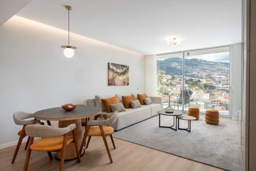 a living room with a couch and a table at Maravilhas II by An Island Apart in Funchal