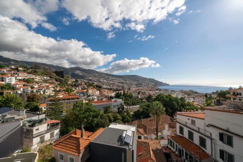 a view of a city with buildings and the ocean at Maravilhas II by An Island Apart in Funchal