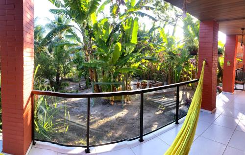 a balcony with a view of a garden at Jacarecica Haus in Maceió