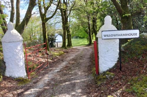 a gate with a sign on a dirt road at Luxurious Self Catering House in Co Donegal in Letterkenny