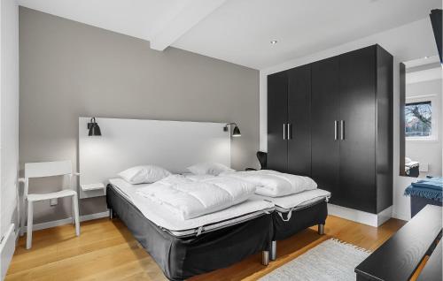 a bedroom with a large bed with a black cabinet at Beautiful Apartment In Ebeltoft in Ebeltoft