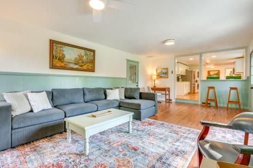 a living room with a couch and a table at Sand Lake Retreat Canal Access and Large Yard! in Tipton