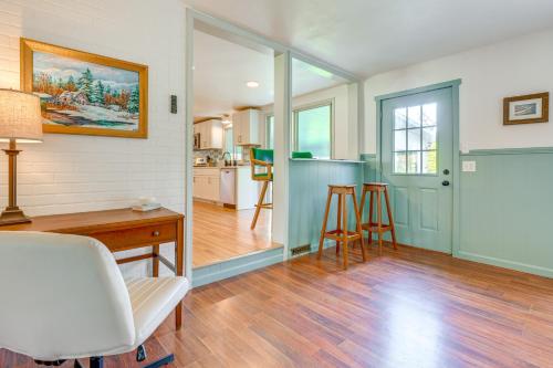 a living room with a desk and a kitchen at Sand Lake Retreat Canal Access and Large Yard! in Tipton
