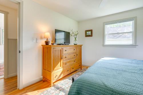 a bedroom with a bed and a tv on a dresser at Sand Lake Retreat Canal Access and Large Yard! in Tipton