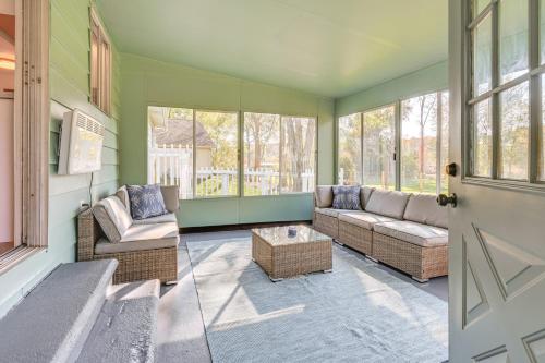 a living room with two couches and a table at Sand Lake Retreat Canal Access and Large Yard! in Tipton