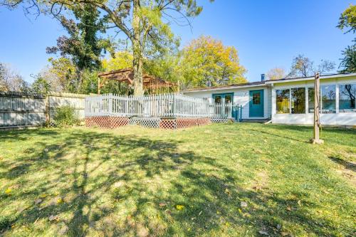 a house with a white fence in a yard at Sand Lake Retreat Canal Access and Large Yard! in Tipton