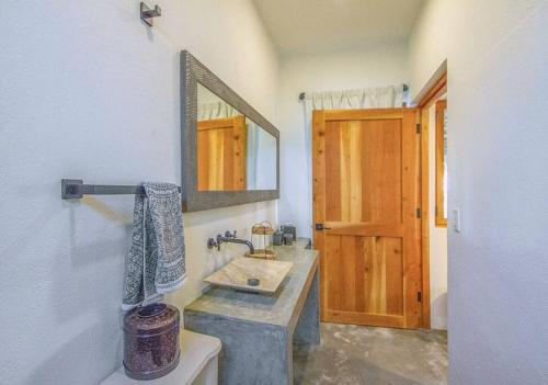 a bathroom with a sink and a mirror at El Escondite - Boutique Casitas in La Playita in San José del Cabo